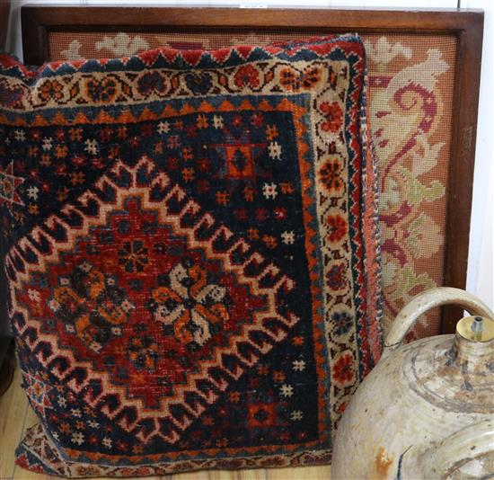 A framed tapestry and a carpet cushion